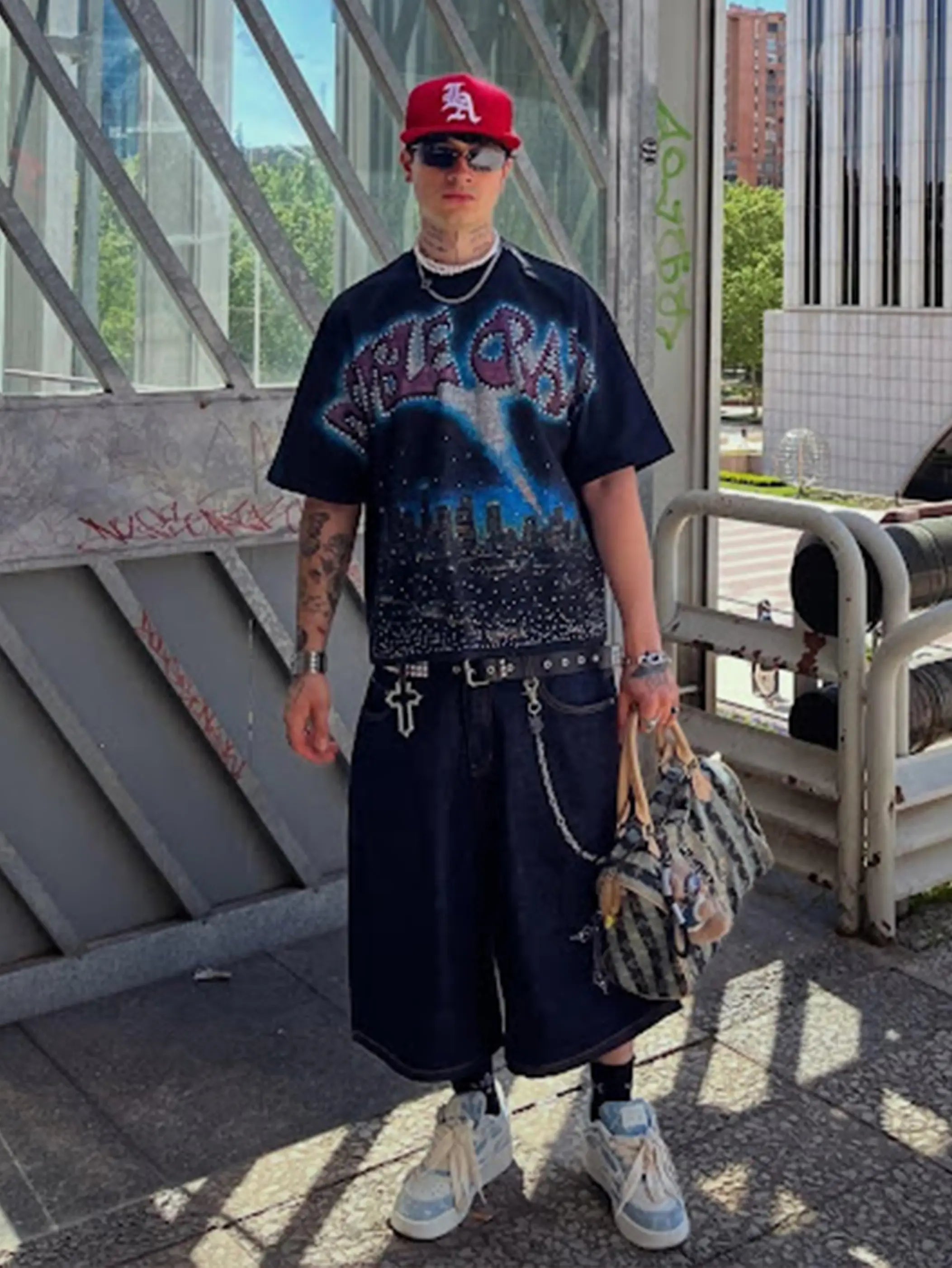 Black graphic tee outfit with jeans and silver chain streetwear styling