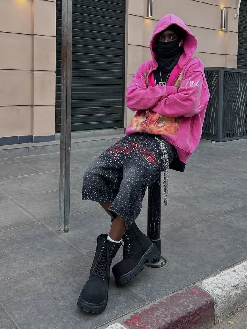 pink statement hoodie with black embellished denim